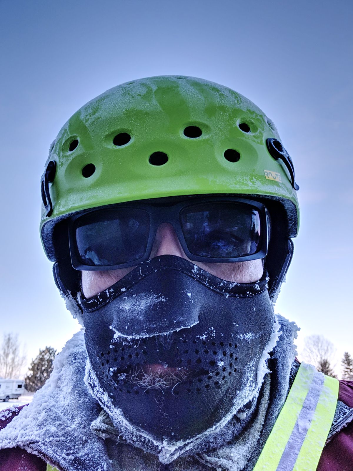 Mountain biker in winter with frost covering his layers