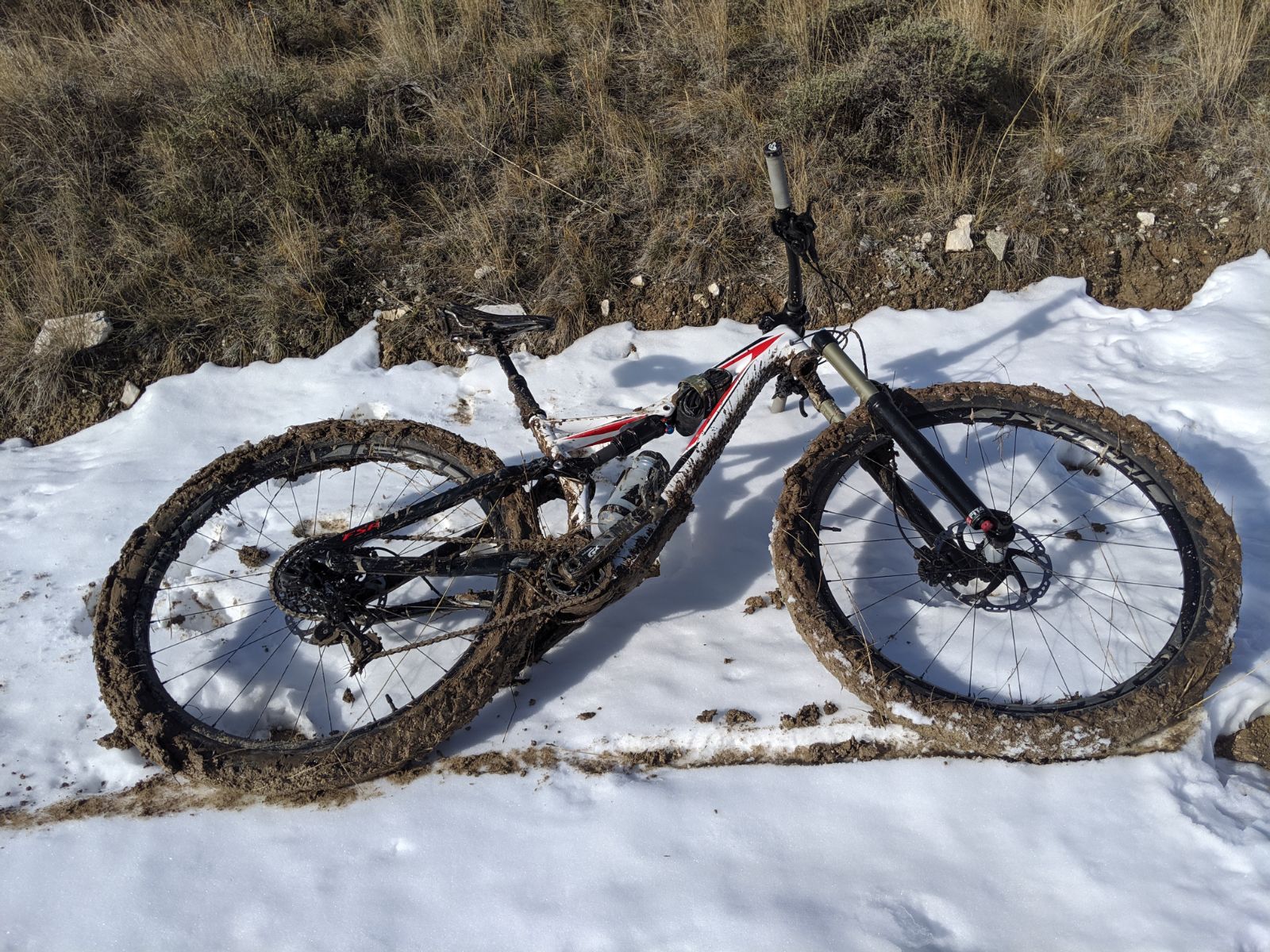 Mountain bike in the snow and mud from thawing frost